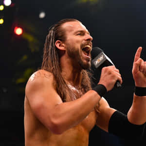 Adam Cole Holding A Microphone And Talking Wallpaper
