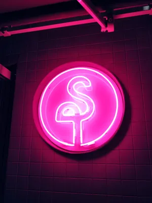 Add Some Flamingo Flair To Your Decor With This Eye-catching Neon-lit Signboard. Wallpaper