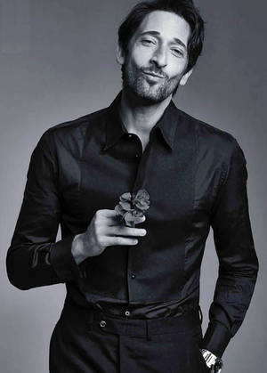Adrien Brody Holding A Flower Wallpaper