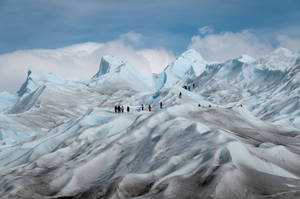 Adventurous Spirit: Ice Mountain Group Climbing Wallpaper