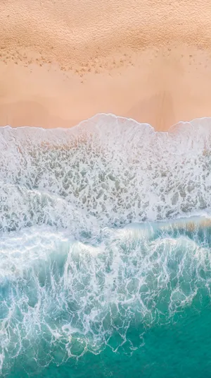 Aerial Photography Of Waves Splashing On White Sand Beach Wallpaper