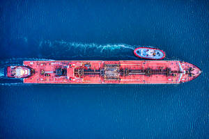 Aerial Shot Of A Red Cargo Ship At Sea Wallpaper