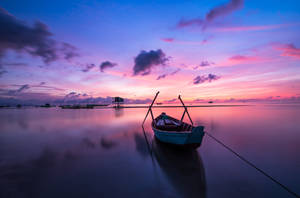 Aesthetic Sky And A Boat On Water Wallpaper