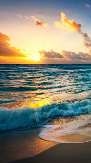Aesthetic Sunset Iphone With Waves Crashing On A Sandy Beach Wallpaper