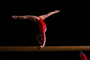 Agility And Mastery - A Professional Swimmer Emerging From The Water Wallpaper