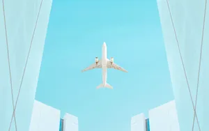 Airplane Framed By Buildings Sky View.jpg Wallpaper