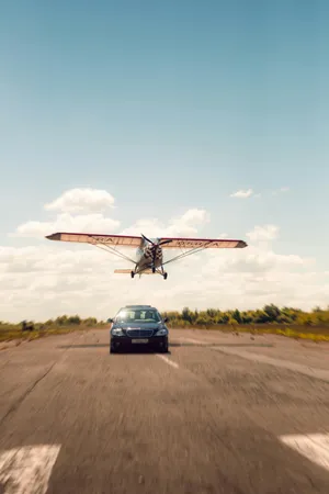 Airplane Landing Above Car Wallpaper