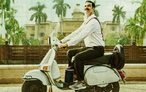 Akshay Kumar Riding Scooter Wallpaper