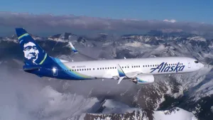 Alaska Airlines Flying Above Snow Mountains Wallpaper