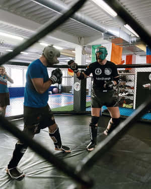 Alexander Volkov Posing Behind A Grate Railing Wallpaper