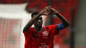 Almoez Ali, Qatar’s Star Striker Gesturing Love Sign In Team Uniform Wallpaper