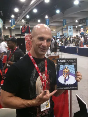 American Aew Wrestler Christopher Daniels Headlocked Comic Convention Wallpaper