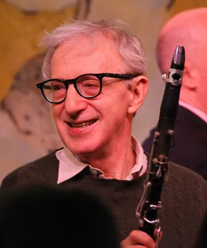American Filmmaker Woody Allen Holding A Saxophone Wallpaper
