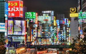 An Aerial View Of Neon Signs At Dusk In Tokyo, Japan. Wallpaper