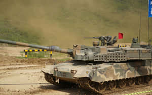An Army Tank Rolling Across A Field Wallpaper