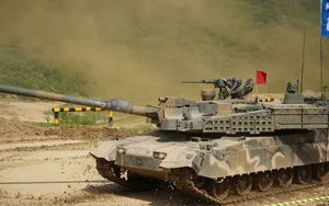 An Army Tank Rolling Across A Field Wallpaper
