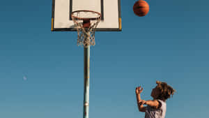 An Empty Basketball Court Waiting For The Next Game. Wallpaper