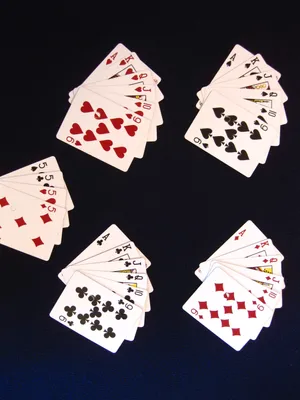 An Engaging Round Of Euchre With A Full Set Of Playing Cards On A Classy Green Felt Table. Wallpaper