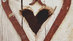 An Intricately Detailed Vintage Heart Carved Out Of Wood. Wallpaper