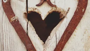 An Intricately Detailed Vintage Heart Carved Out Of Wood. Wallpaper