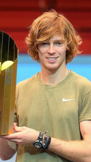 Andrey Rublev Holding A Gold Trophy Wallpaper