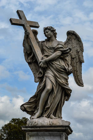 Angel Statue Under White Clouds During Daytime Wallpaper