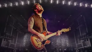 Arijit Singh Playing An Electric Guitar Wallpaper
