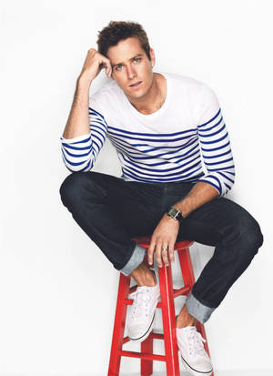 Armie Hammer At Red Chair Wallpaper