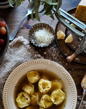 Aromatic Tortellini In Brodo Served On A Table Wallpaper