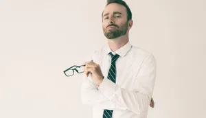 Arrogant Man Holding Eyeglasses Wallpaper