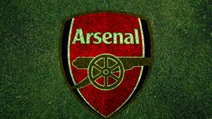 Arsenal Logo On Grass Field Wallpaper