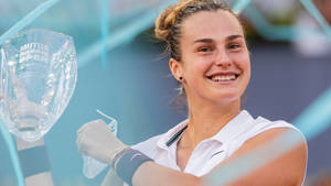 Aryna Sabalenka Holding Mutua Madrid Open Trophy Wallpaper