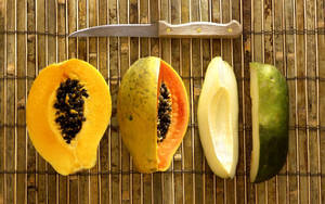 Assorted Ripe And Unripe Papaya Fruits Wallpaper