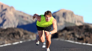 Athlete Running In Road Wallpaper