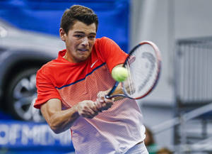 Athlete Taylor Fritz Hitting The Ball Wallpaper