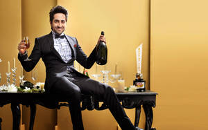 Ayushmann Khurrana Holding A Wine Glass Wallpaper