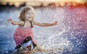 Baby Girl Playing Water Wallpaper