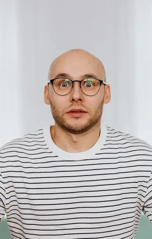 Bald Man With Wide Eyes Wallpaper