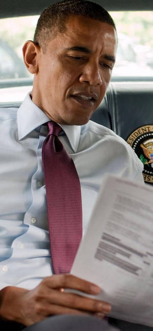 Barack Obama Engrossed In Deep Reading Wallpaper