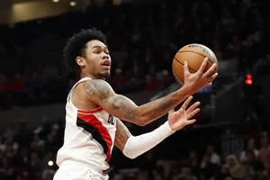 Basketball Player In Action Layup Attempt Wallpaper