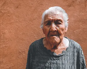 Beautiful Older Woman On Brown Wallpaper