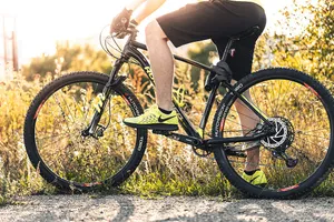 Bike Lover In Yellow Nike Shoes Wallpaper