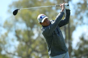 Billy Andrade Swinging A Golf Club Wallpaper