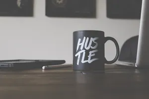 Black And White Hustle-printed Ceramic Mug On Table Wallpaper