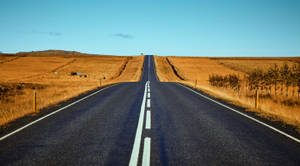 Black Asphalt Road Between Brown Fields During Daytime Wallpaper