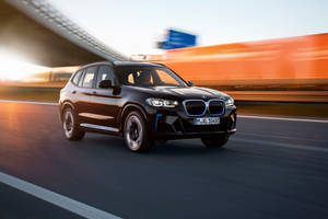 Black Bmw Speeding On The Highway Wallpaper