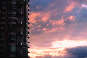 Black Concrete Building Under Cloudy Sky During Daytime Wallpaper