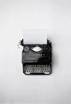 Black Fayorit Typewriter With Printer Paper Wallpaper