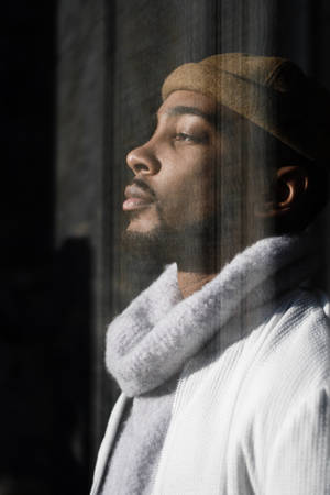 Black Man By A Glass Window Wallpaper