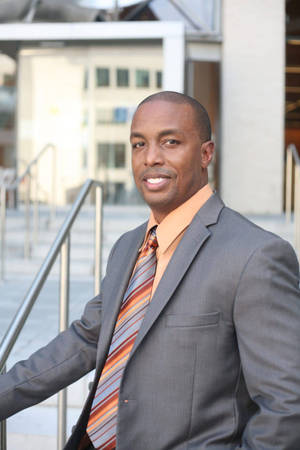 Black Man In Orange And Gray Suit Wallpaper